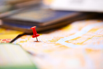 pins marking travel itinerary points on map and passport