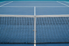 Horizontal High Angle No People Conceptual Shot Of Modern Tennis Court With Blue Floor And Net, Copy Space