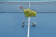 © Clique Images - Horizontal no people high angle shot of trolley full of tennis balls and net in court, professional sport concept, copy space