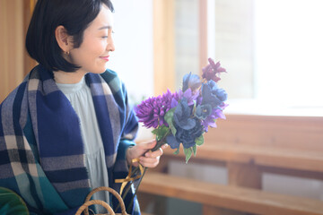 Profile of a beautiful woman bundling flowers