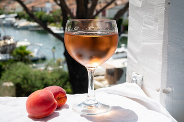 Drinking of cold rose wine from Provence with view on yacht harbour of Port Grimaud, summer vacation on French Riviera, France