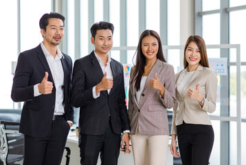 Millennial Asian professional successful male businessmen and female  businesswomen group in formal suit standing smiling side by side bonding together in company office meeting room