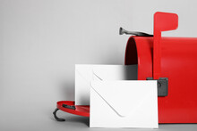 Open Red Letter Box With Envelopes On Light Background, Closeup. Space For Text