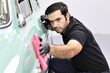 © Thongtawat - Car detailing - the man holds the microfiber in hand and polishes the car.