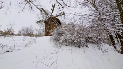 Canvas Print - Snowy hill with old windmill, Mamajeva Sloboda Cossack Village, Kyiv, Ukraine