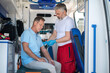 © zinkevych - Ambulance doctor preparing the patient for an intravenous infusion procedure