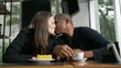 © Marco - Happy couple kissing dating at coffee shop. Diversity concept of two people kiss. Woman leaning head on boyfriend shoulder showing love and affection