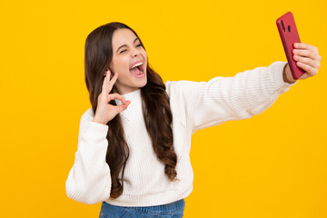 Canvas Print - Excited teenager girl. Portrait of cute teenage girl using mobile phone, chatting on web, typing sms message. Mobile app for smartphone. Children lifestyle concept. Mock up copy space.