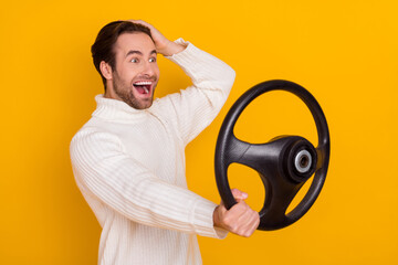 Wall Mural - Profile photo of astonished guy hold steering wheel hand head wear white pullover isolated yellow color background