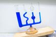 © Menyhert - Glass equipment where several different tubes are filled with blue liquid, demonstrating the law of communicating vessels. Used in physics class.