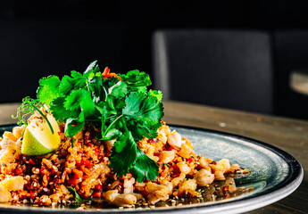 Wall Mural - Fried rice with chicken and vegetables in plate on wooden table background