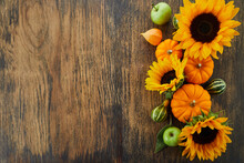 Pumpkin And Sunflowers Over Old Wooden Background With Copy Space. Autumn Background Decoration.