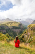 Panorama of the Caucasus Mountains in Georgia, viewed by a woman

