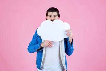 Wall Mural - Man holding a cloud shape blank thinkboard and having fun