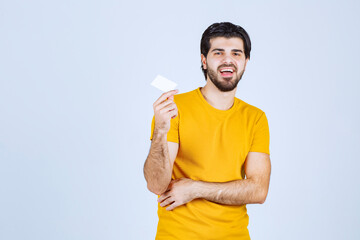 Canvas Print - Man showing his business card and presenting himself with a confidence