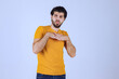 Man in yellow shirt giving seductive and appealing poses