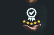 © olando - Businessman holding and showing the best quality assurance with golden stars. Quality control certification and standardization. ISO service concept.