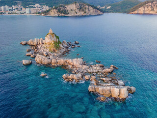 Sveta Nedelja is an islet on the Adriatic Sea, in Montenegrin municipality of Budva. It is located opposite the town of Petrovac na Moru in Montenegro. It has a small church on it Portrait of a