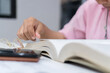 © smolaw11 - Asian people opening books for education learning textbook literature near shelf in bookshelf at collegein library academic, read with glasses. Relaxing hobby to learn in knowledge education study