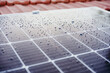 close up of water drops on solar panel on roof during sunrise.Renewable energies and green energy concept
