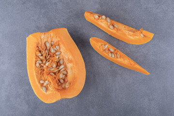 Two pieces of pumpkin , on the marble background