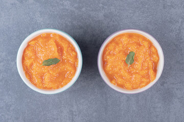 Two bowl of lentil soup, on the marble background