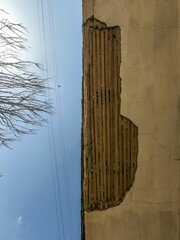 Sticker - Vertical shot of an old house ruins with branches and blue sky