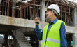 engineer using walkie-talkie communicate with worker at construction site