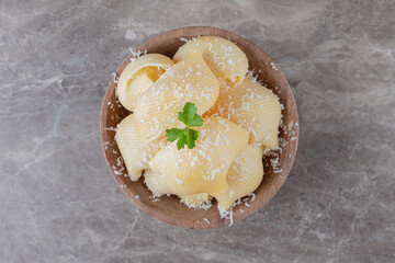 Pasta in a small bowl , on the marble background