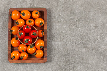 Wall Mural - Pile of red and yellow tomatoes on wooden board