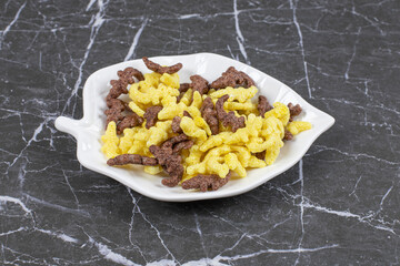 Two types of cereal flakes on leaf shaped plate