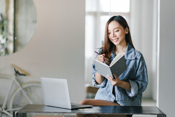 Asian female college student reading a book in a cafe girl working in a cafe