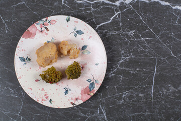 Meat and broccoli on the plate , on the marble background