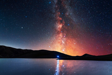 Wall Mural - Beautiful night landscape. Small lake and mountains on the bright milky way galaxy. Starry  night.