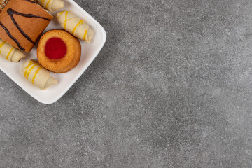 Wall Mural - Plate of various desserts on marble background