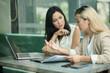 © DragonImages - Businesswoman Looking at Speaking Colleague