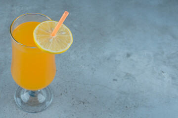 Wall Mural - Delicious orange juice with slice of lemon and straw