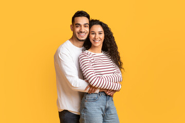 Wall Mural - Portrait Of Loving Arab Man And Woman Embracing And Smiling At Camera