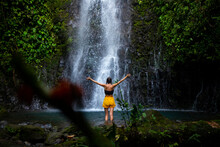 Brave Girl Stands In Front Of A Mighty Waterfall With Her Hands Raised In The Air; Celebration Of A Successful Climb Over A Waterfall; Tropical Waterfall In Costa Rica; Hidden Gems Of Costa Rica