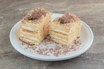 Slices of napoleon cake on white plate