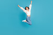 Full length photo of delighted astonished person jump raise fists achievement isolated on blue color background