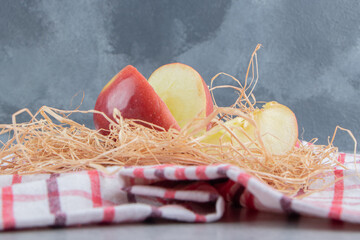 Wall Mural - Apple slices and straw on a towel on marble background