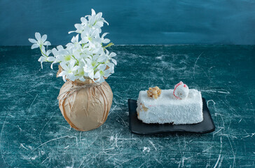 Wall Mural - A tasty piece of cake with nut and vase of flower