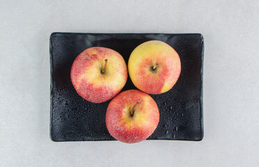 Wall Mural - Fresh red apples on black plate