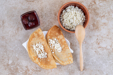 Wall Mural - Roll pancakes with cottage cheese and strawberry jam