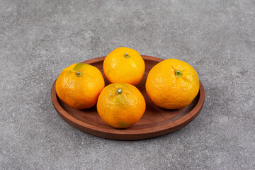 Wall Mural - Fresh sweet tangerines on a wooden kitchen board