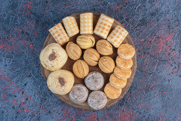 Wall Mural - A delectable pastry assortment on a wooden board on abstract background