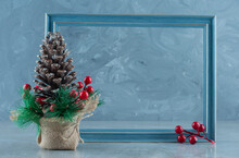 Festive Decoration Made Of Pine Cone And An Empty Picture Frame On Marble Background