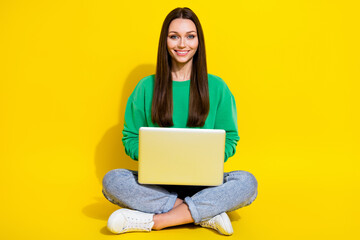 Poster - Full size photo of pretty young girl use laptop study remote college dressed trendy green sweatshirt isolated on yellow color background