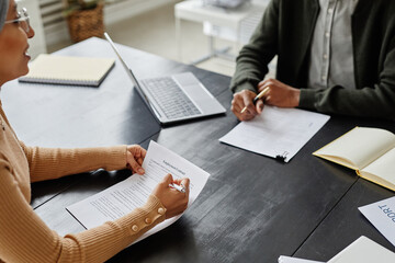 Close up of HR manager holding employment contract in job interview for office position, copy space